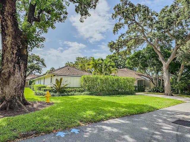 11373 Twelve Oaks Way E, North Palm Beach, FL 33408 - view of home's exterior featuring a yard and driveway