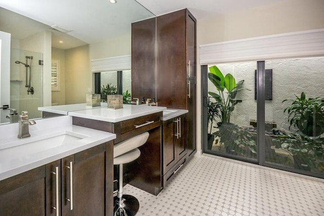 bathroom featuring a shower, recessed lighting, and vanity