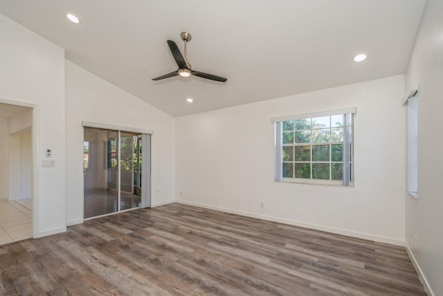 unfurnished room featuring ceiling fan, lofted ceiling, and dark hardwood / wood-style flooring