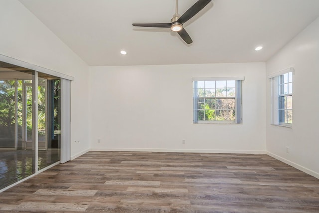 unfurnished room featuring vaulted ceiling, dark hardwood / wood-style floors, and ceiling fan