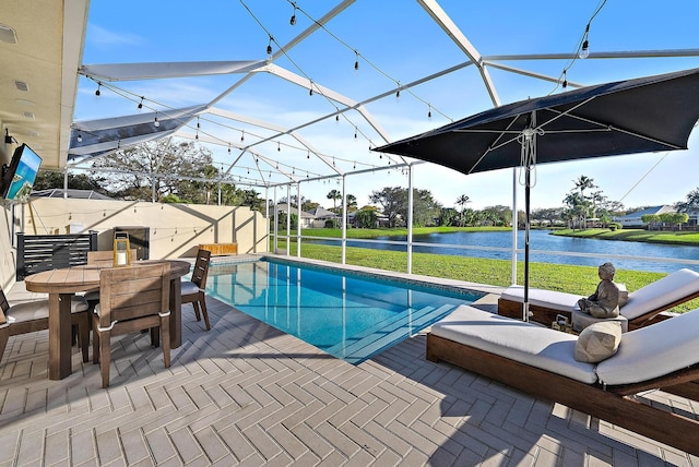 view of swimming pool with a water view, a lanai, and a patio