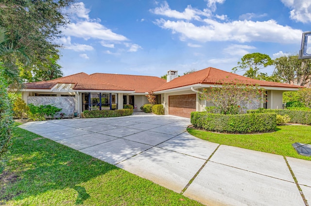 view of front of home featuring a garage and a front lawn