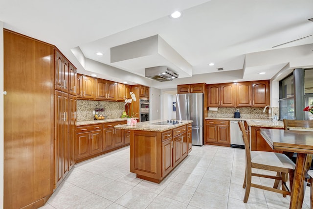 kitchen featuring a kitchen island, appliances with stainless steel finishes, sink, decorative backsplash, and light tile patterned floors