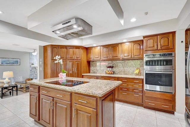 kitchen featuring extractor fan, a kitchen island, stainless steel double oven, black electric stovetop, and backsplash