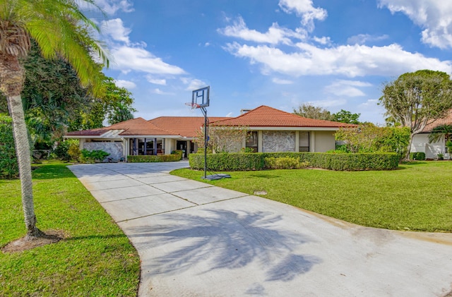 single story home with a garage and a front lawn