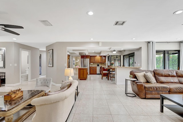 tiled living room with ceiling fan