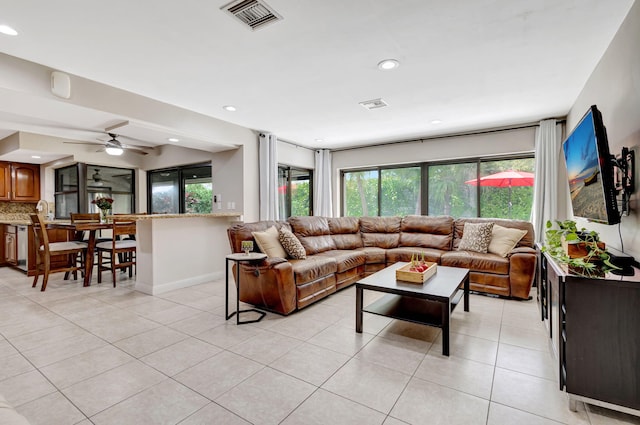 tiled living room featuring ceiling fan and plenty of natural light