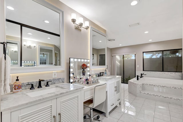 bathroom featuring tile patterned flooring, vanity, and tiled bath