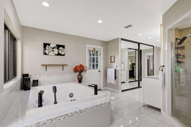 bathroom featuring vanity and plus walk in shower