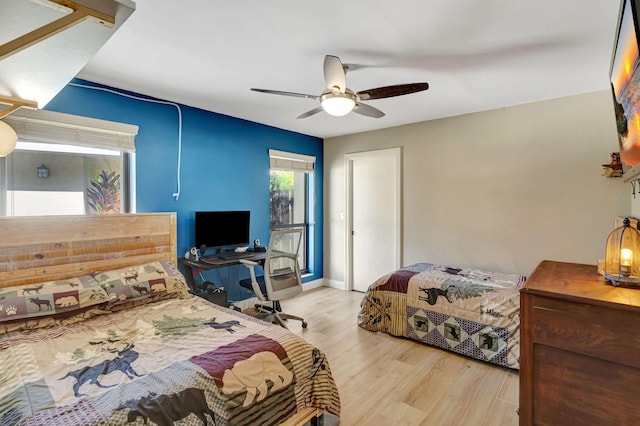 bedroom with light hardwood / wood-style floors and ceiling fan