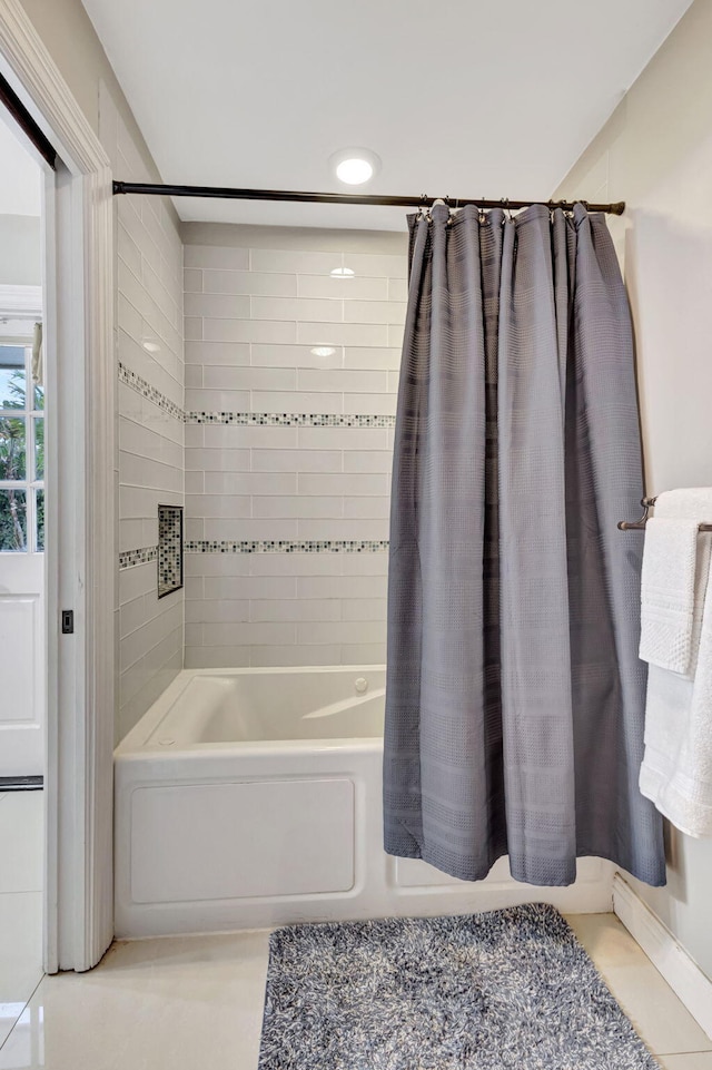 bathroom featuring tile patterned floors and shower / bath combo with shower curtain