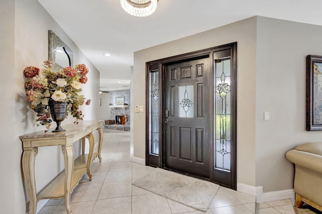 tiled foyer entrance with a fireplace