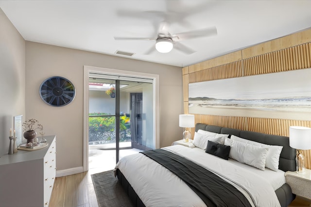 bedroom featuring access to exterior, light hardwood / wood-style flooring, and ceiling fan