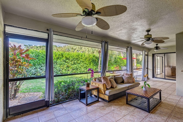 sunroom featuring ceiling fan