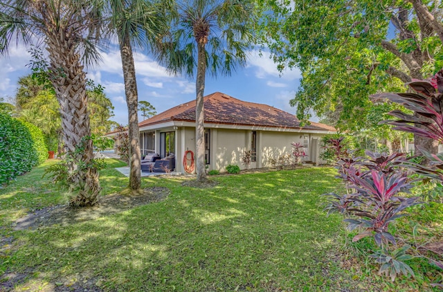 view of front of property with a patio and a front lawn