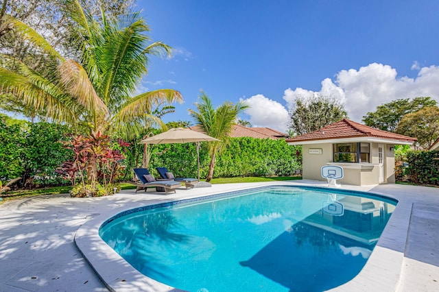 view of pool featuring an outdoor structure and a patio area