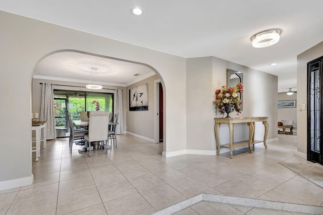 dining room featuring crown molding and light tile patterned floors