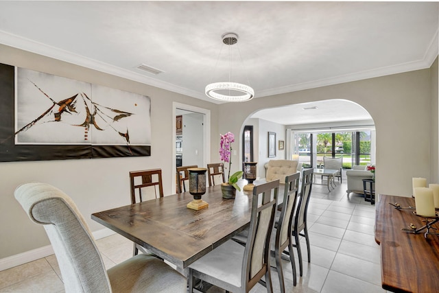 dining area featuring ornamental molding and light tile patterned floors