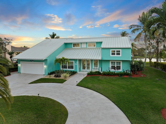 2666 SE Erickson Dr, Port Saint Lucie, FL 34984 - view of front facade featuring a garage and a lawn