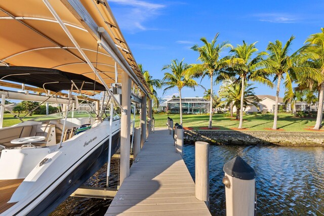 2666 SE Erickson Dr, Port Saint Lucie, FL 34984 - view of dock featuring a yard and a water view
