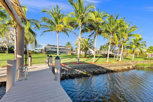 2666 SE Erickson Dr, Port Saint Lucie, FL 34984 - view of dock with a lawn, glass enclosure, and a water view