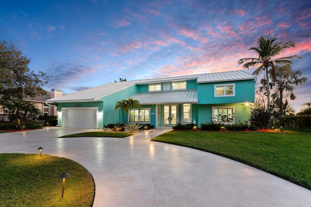 2666 SE Erickson Dr, Port Saint Lucie, FL 34984 - view of front of home with a garage and a yard