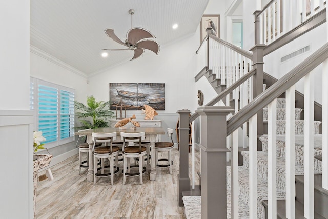 2666 SE Erickson Dr, Port Saint Lucie, FL 34984 - dining room featuring crown molding, light hardwood / wood-style flooring, high vaulted ceiling, and ceiling fan