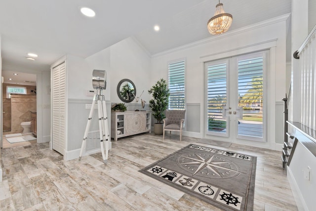 2666 SE Erickson Dr, Port Saint Lucie, FL 34984 - foyer entrance with crown molding, vaulted ceiling, light hardwood / wood-style floors, and french doors