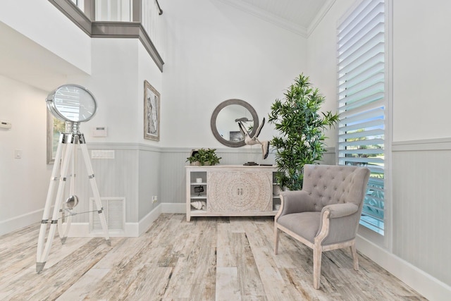 2666 SE Erickson Dr, Port Saint Lucie, FL 34984 - living area featuring crown molding and light hardwood / wood-style flooring