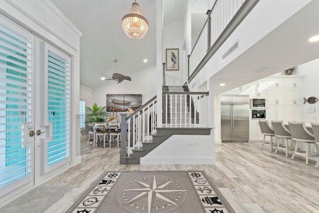 2666 SE Erickson Dr, Port Saint Lucie, FL 34984 - entrance foyer with ornamental molding, high vaulted ceiling, elevator, and light wood-type flooring