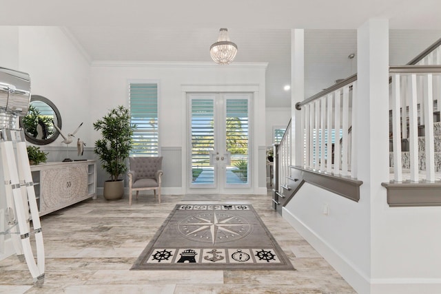 2666 SE Erickson Dr, Port Saint Lucie, FL 34984 - entryway featuring ornamental molding, wood-type flooring, an inviting chandelier, and french doors
