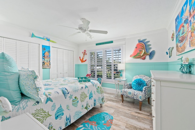 2666 SE Erickson Dr, Port Saint Lucie, FL 34984 - bedroom with hardwood / wood-style floors, crown molding, ceiling fan, and two closets
