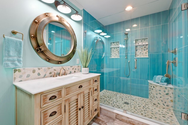 2666 SE Erickson Dr, Port Saint Lucie, FL 34984 - bathroom with vanity, tasteful backsplash, and a shower with door