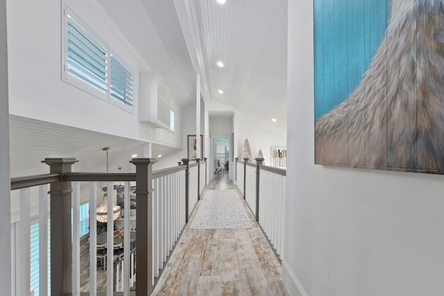 2666 SE Erickson Dr, Port Saint Lucie, FL 34984 - hallway featuring beamed ceiling, high vaulted ceiling, and light hardwood / wood-style flooring