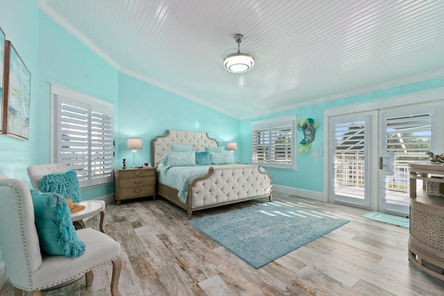 2666 SE Erickson Dr, Port Saint Lucie, FL 34984 - bedroom with crown molding, vaulted ceiling, access to outside, and light hardwood / wood-style floors