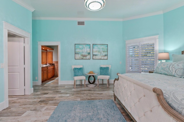 2666 SE Erickson Dr, Port Saint Lucie, FL 34984 - bedroom with ensuite bath, light hardwood / wood-style flooring, and ornamental molding