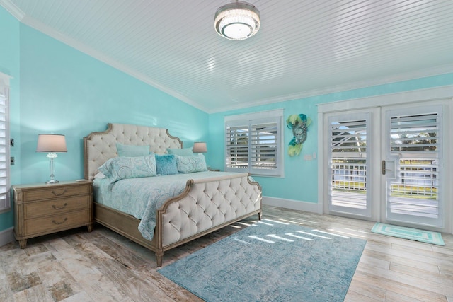 2666 SE Erickson Dr, Port Saint Lucie, FL 34984 - bedroom with ornamental molding, lofted ceiling, access to outside, and light hardwood / wood-style flooring
