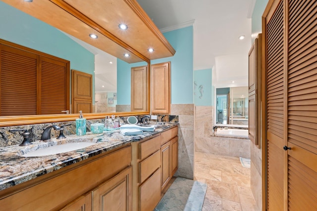 2666 SE Erickson Dr, Port Saint Lucie, FL 34984 - bathroom with vanity, ornamental molding, tile walls, and a bathtub