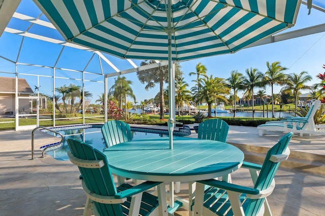 2666 SE Erickson Dr, Port Saint Lucie, FL 34984 - view of patio / terrace with glass enclosure and a water view
