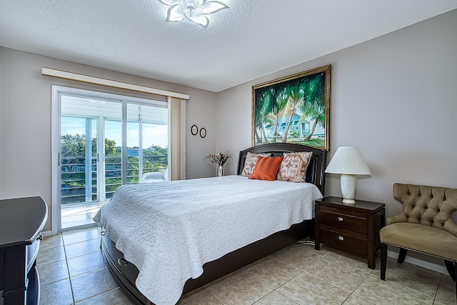 tiled bedroom featuring access to exterior and a textured ceiling