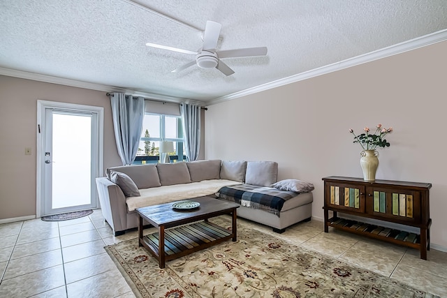 living room with ceiling fan, ornamental molding, a textured ceiling, and light tile patterned floors