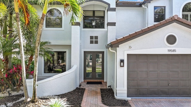 view of exterior entry featuring french doors