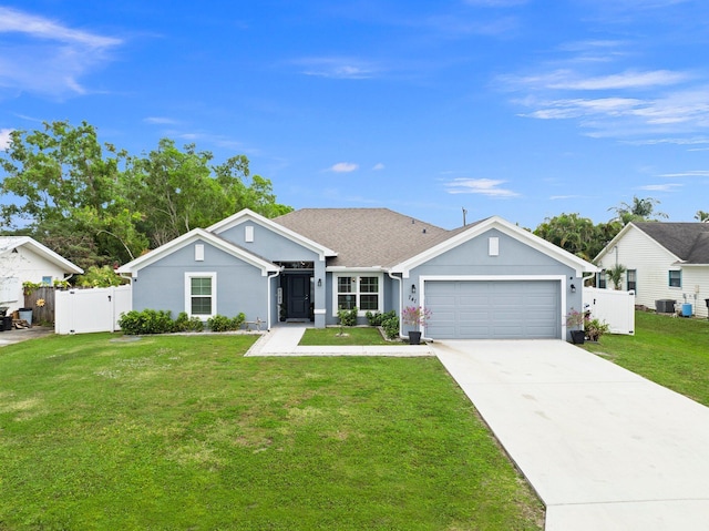 view of front facade with a garage, a front yard, and central air condition unit