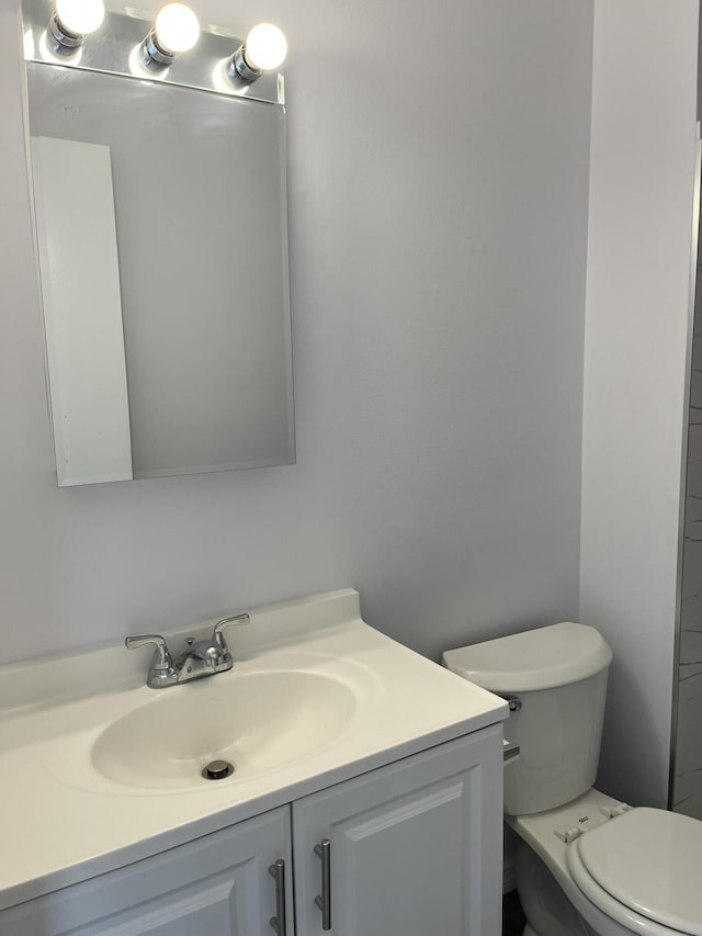 bathroom featuring toilet and vanity