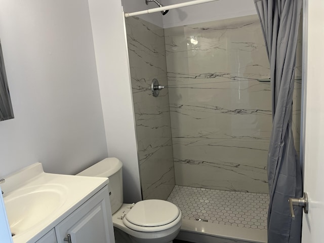 full bathroom with toilet, a marble finish shower, and vanity