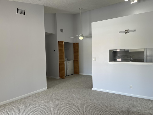 interior space with baseboards, light colored carpet, visible vents, and washer and dryer