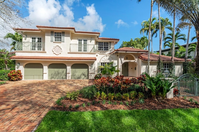 mediterranean / spanish-style house featuring a balcony and a garage