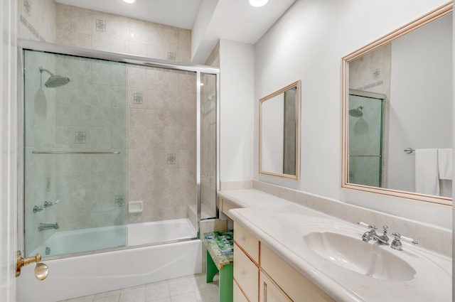 bathroom featuring tile patterned flooring, enclosed tub / shower combo, and vanity