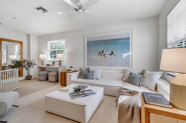 living room with light colored carpet and ceiling fan