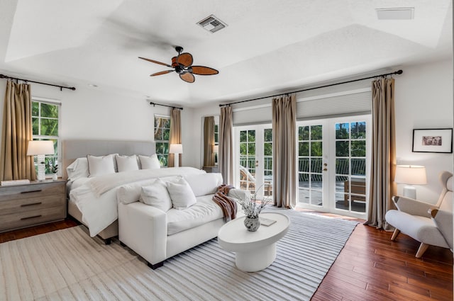 bedroom featuring wood-type flooring, access to outside, ceiling fan, a textured ceiling, and french doors